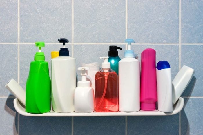 A shower shelf full of hair products