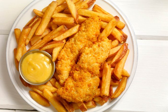 plate with fried chicken and french fries
