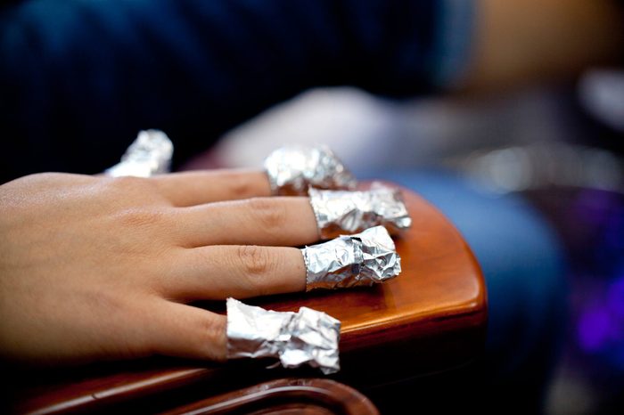 hand with nails wrapped in foil