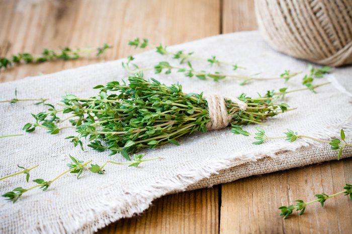 sprig of thyme on a dish towel tied with twine
