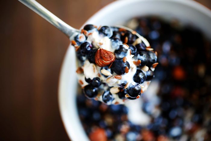 yogurt with fruit in spoon