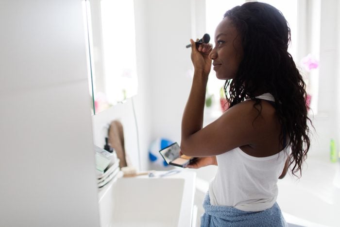 woman applying make up in the morning