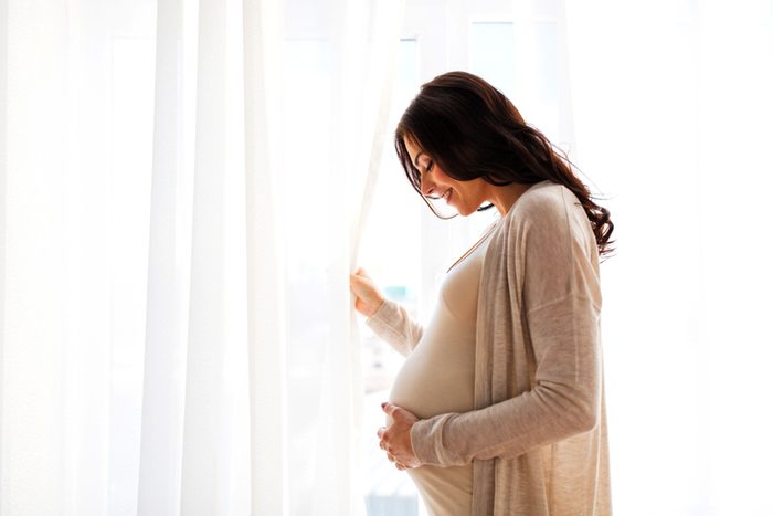 pregnant woman at window
