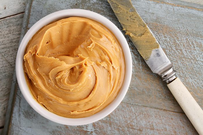 bowl of peanut butter with knife