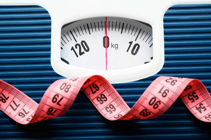 Weight scale with red measuring tape