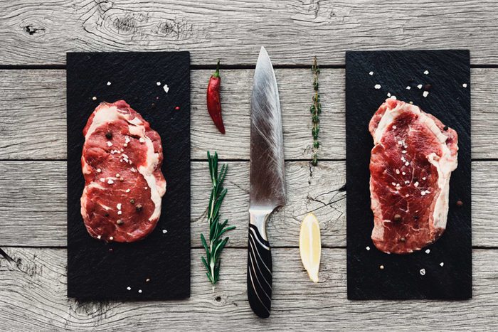 meat on cutting board with rosemary