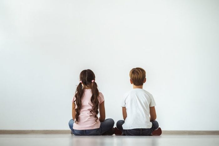young girl and young boy sitting together
