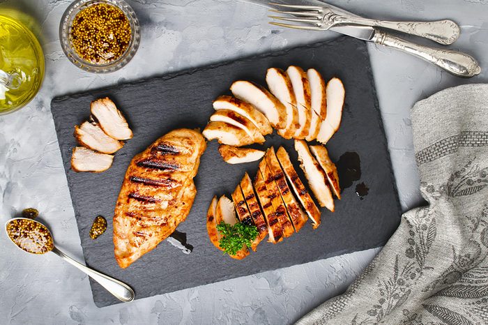 Grilled chicken on a cutting board.
