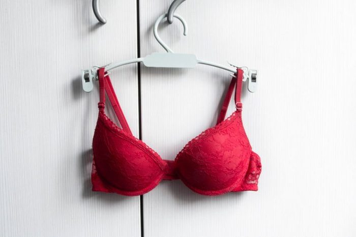 red bra on a hangar with white background