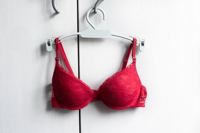 red bra on a hangar with white background