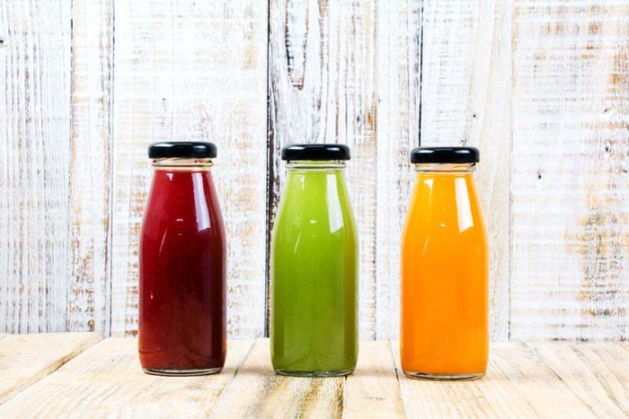 Three bottles of juice: one red, one green and one orange