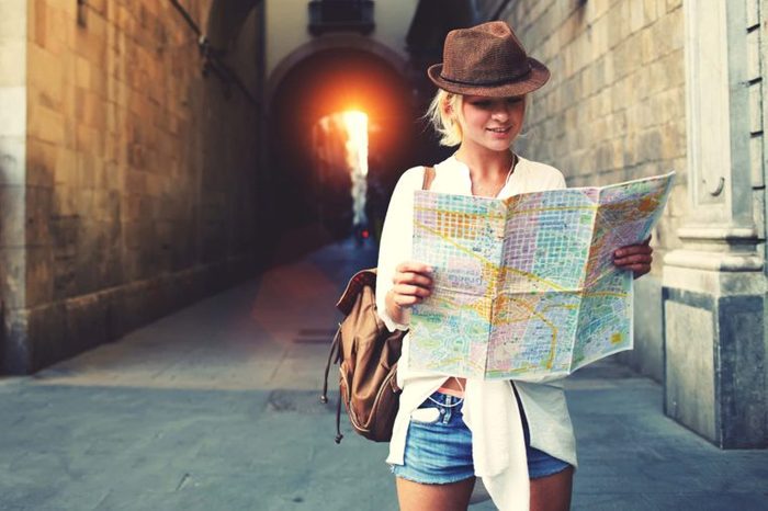 woman in jaunty hat holding map