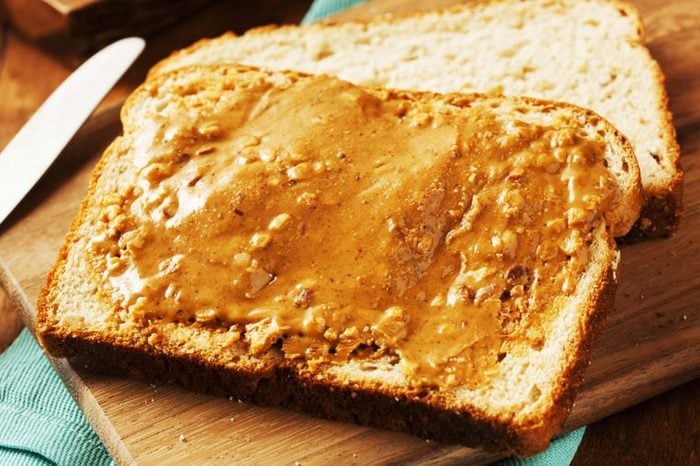 Piece of bread slathered with peanut butter
