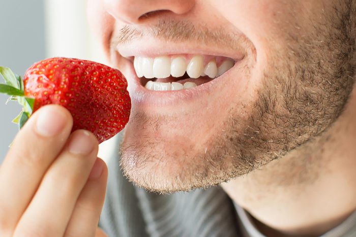 teeth biting a strawberry