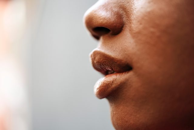 side view cropped shot of woman's lips and nose