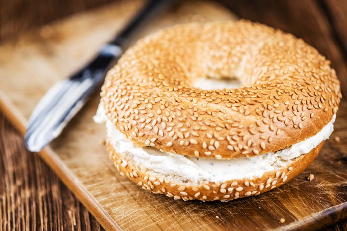 Sesame bagel with cream cheese.
