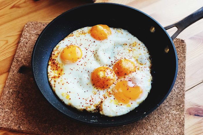 Fried eggs in a skillet.