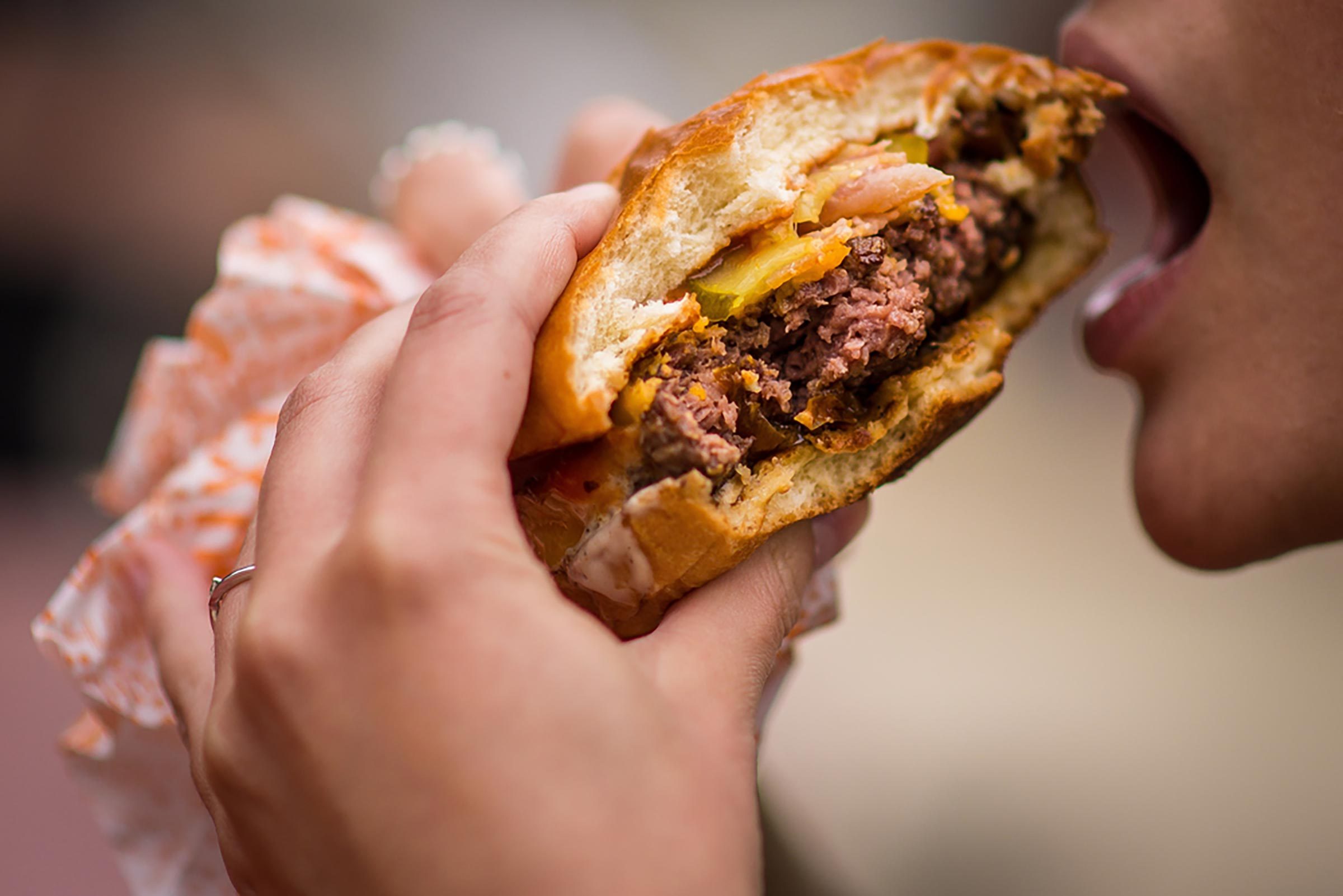 hands holding burger