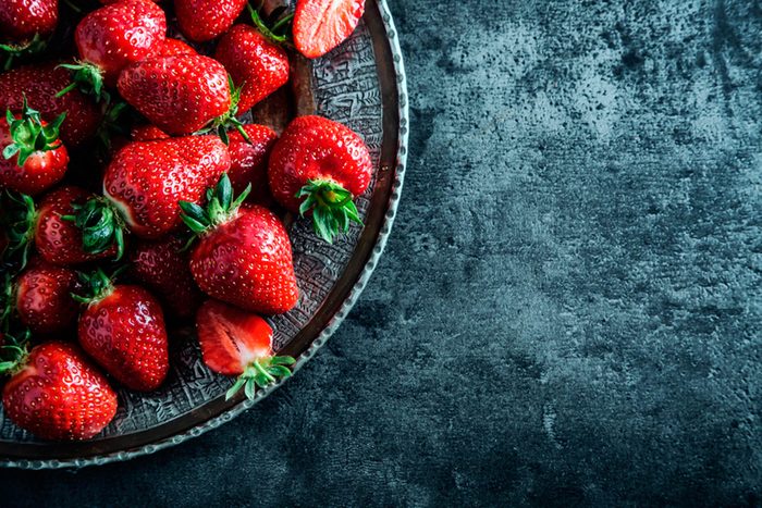 strawberries on a deep blue dish