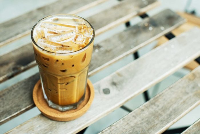 glass of iced coffee on wood surface