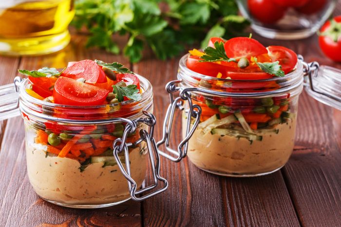 Snack-size jars of hummus and veggies.