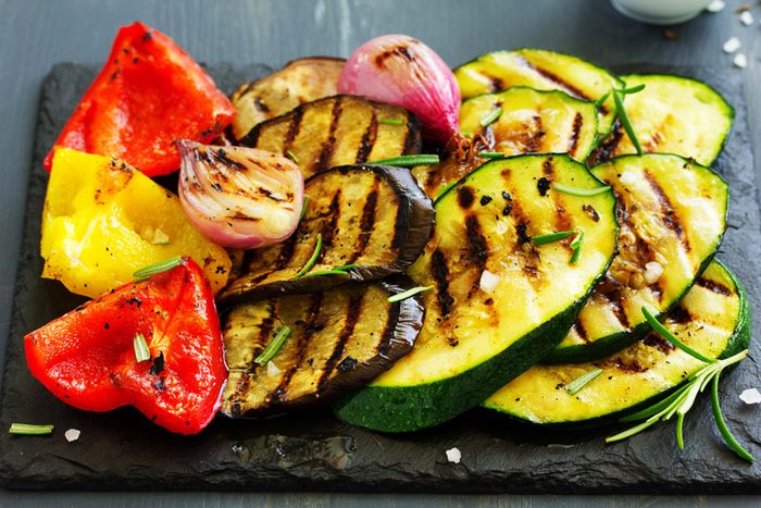 grilled vegetables, peppers, eggplant, zucchini, on dark slate surface
