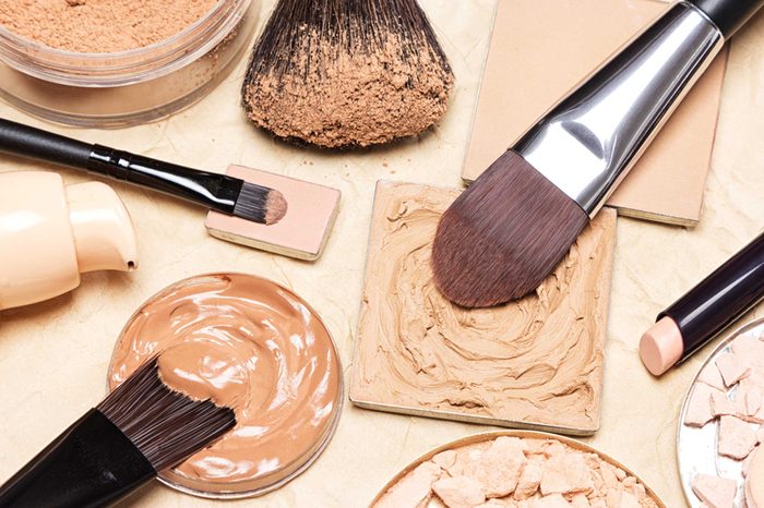 Makeup brushes in foundation palettes. 