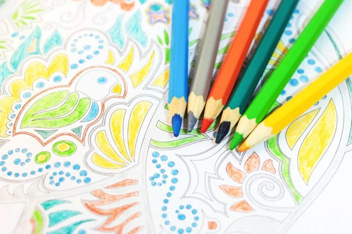 Colored pencils and an adult coloring book.