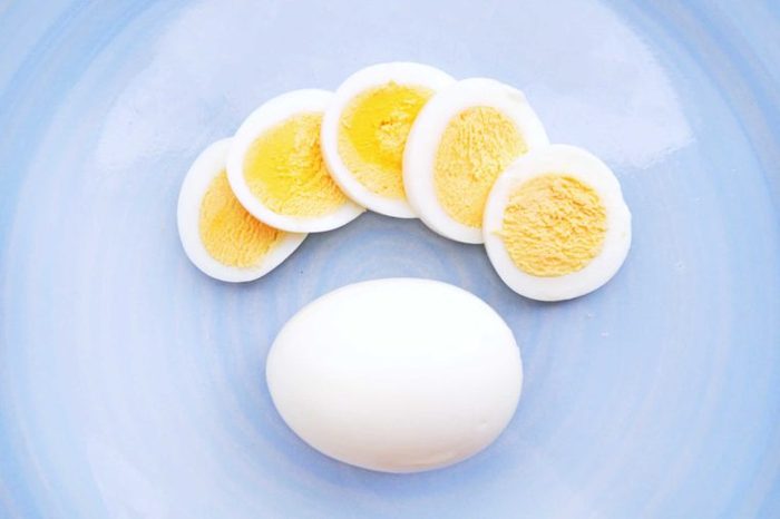 hard-boiled egg slices next to a whole hard-boiled egg