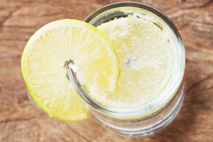top down shot of seltzer in a glass with a lemon wedge