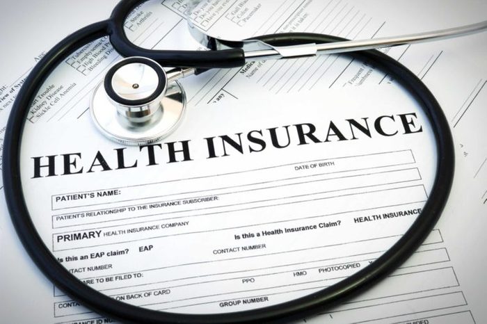 Closeup of a health insurance form and a stethoscope.