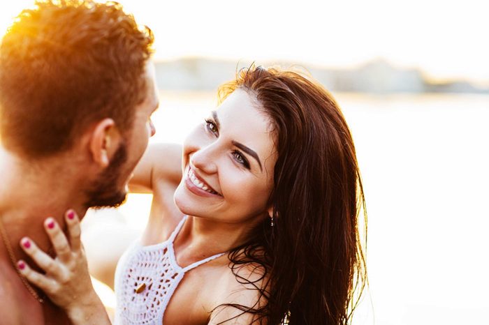 woman with brunette hair looking into a man's eyes