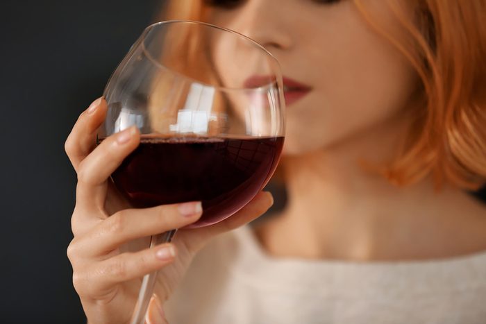 woman sipping red wine