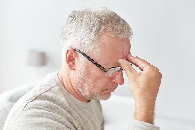stressed older man with hand on forehead