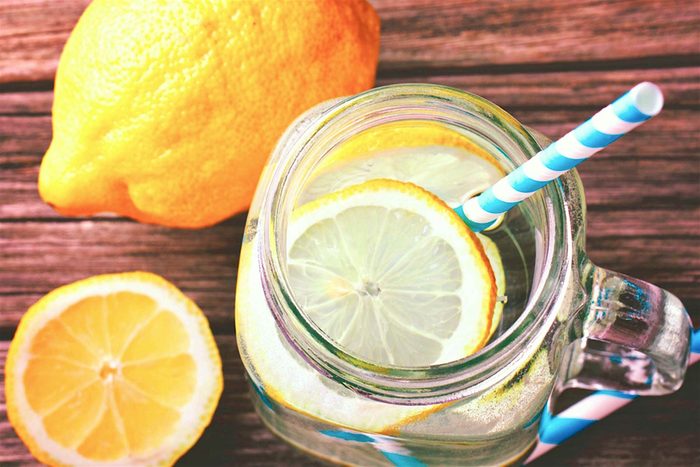 lemon water in jar with straw 
