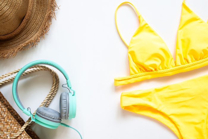 yellow bikini with headphones and straw hat