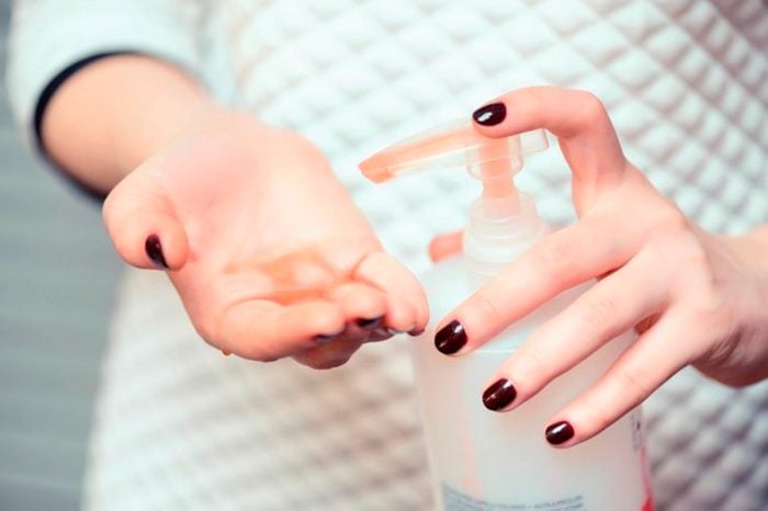 woman putting moisturizer on hands