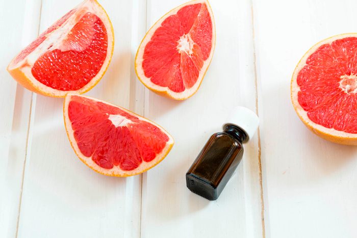 ruby grapefruit slices with essential oil bottle