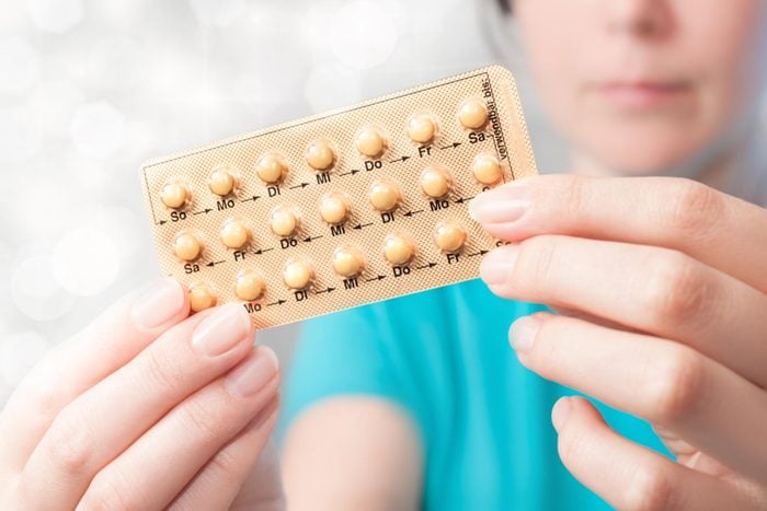 woman with birth control pills