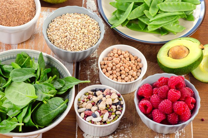Healthful fresh foods, including spinach, raspberries, avocado and chickpeas