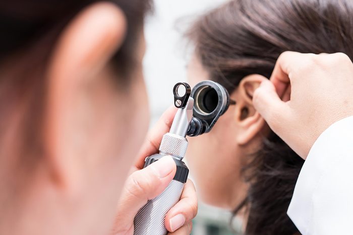 doctor looking into patient's ear