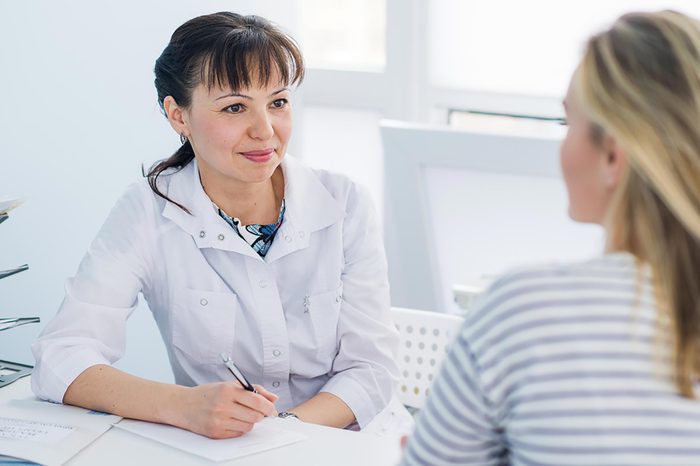 Female doctor listening to female patient