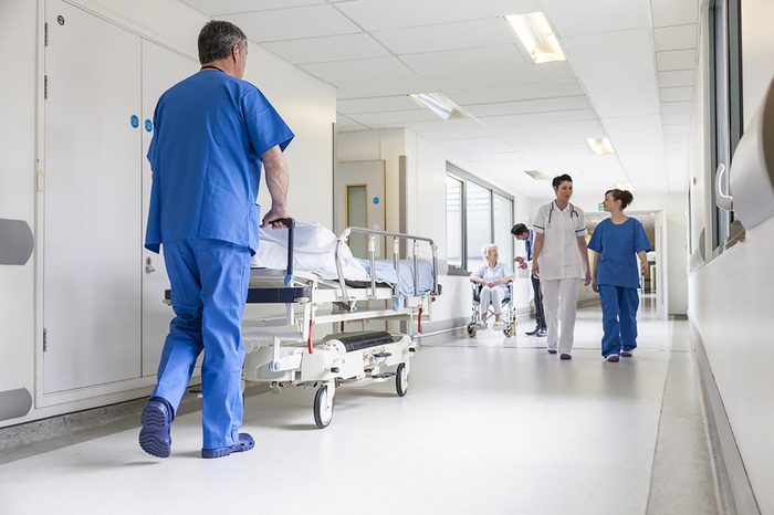 a hospital corridor with doctors, nurses, and patients