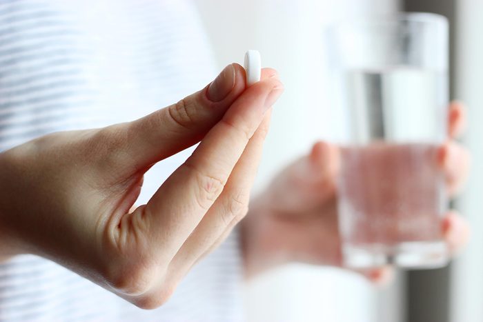 supplements with glass of water
