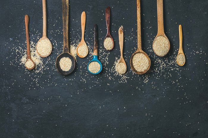 wooden spoons filled with quinoa