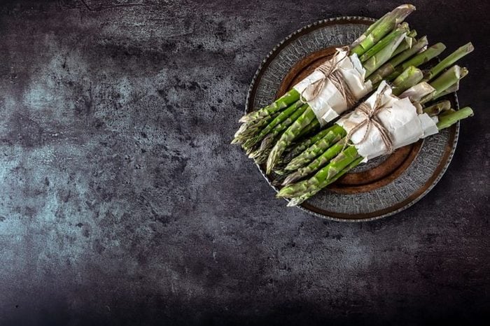 two bundles of asparagus on a plate