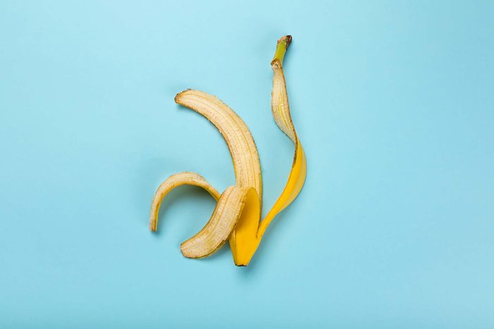 Banana peel on a teal background