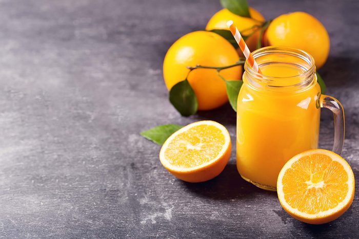 Orange juice and whole oranges.