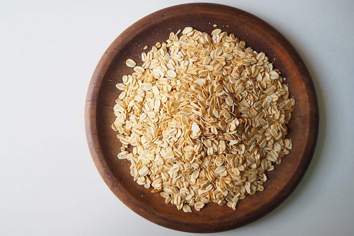 dry Oatmeal on a wooden bowl