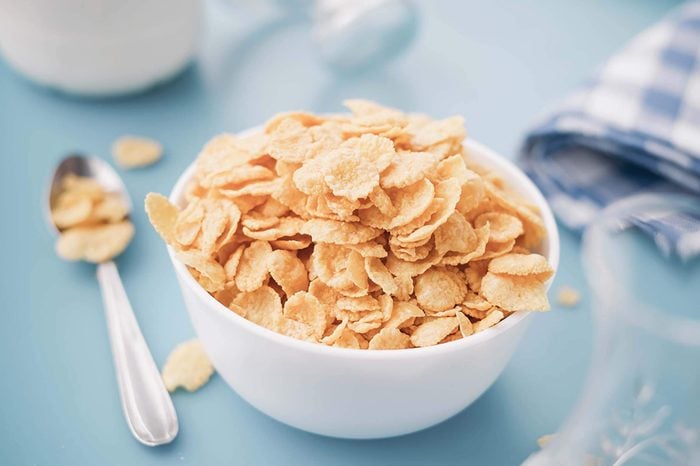 Cereal flakes in a white bowl on a blue table